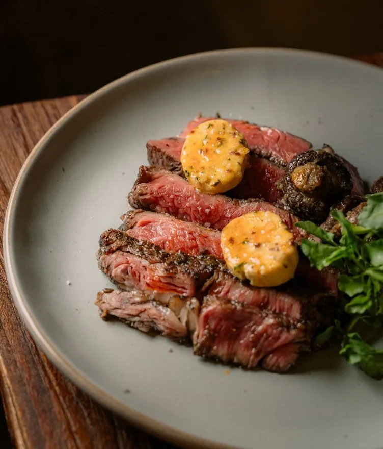 Sliced Australian rib eye topped with black garlic miso butter