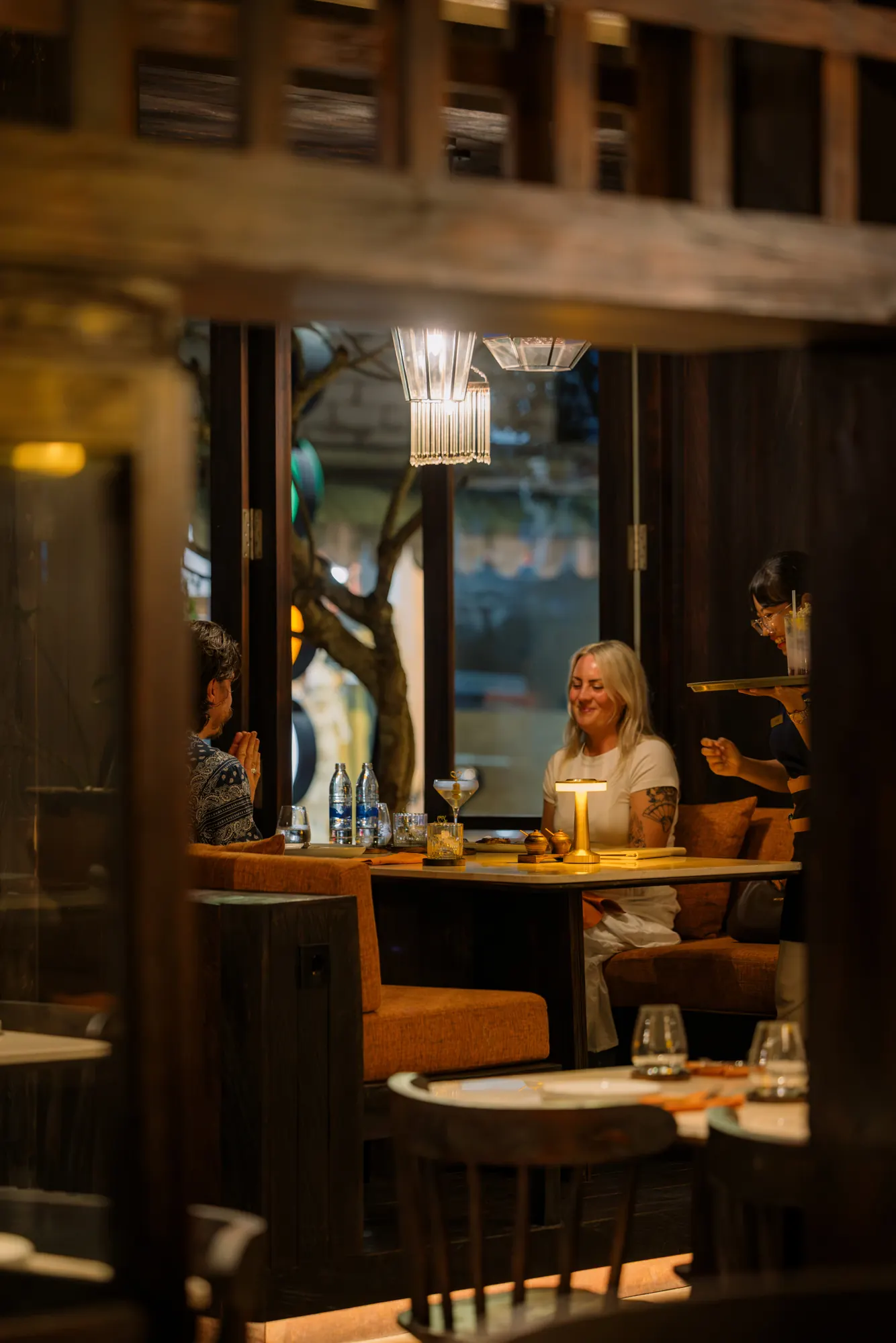 Guests at a candlelit table in the dining room