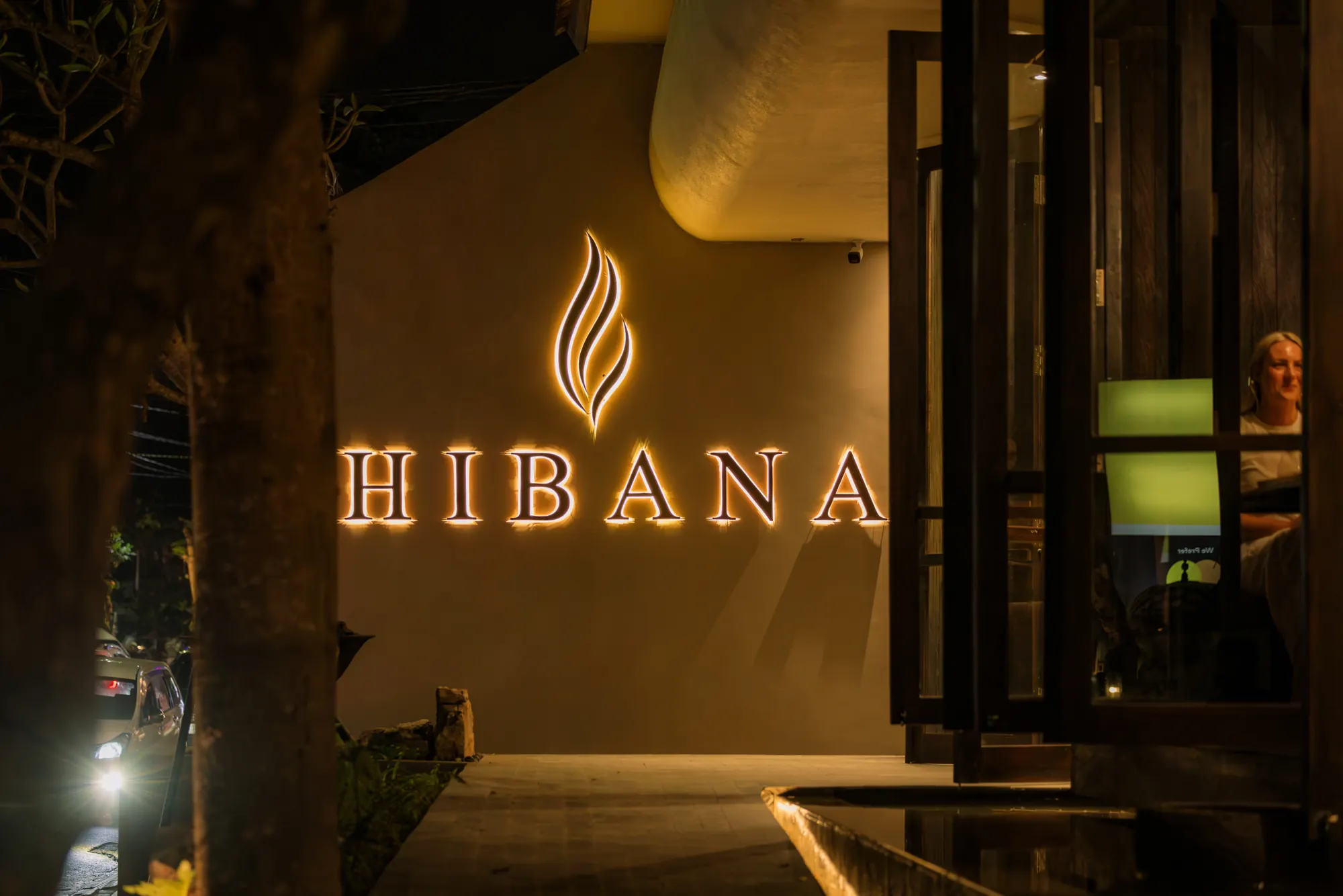 The illuminated Hibana sign at the entrance at night