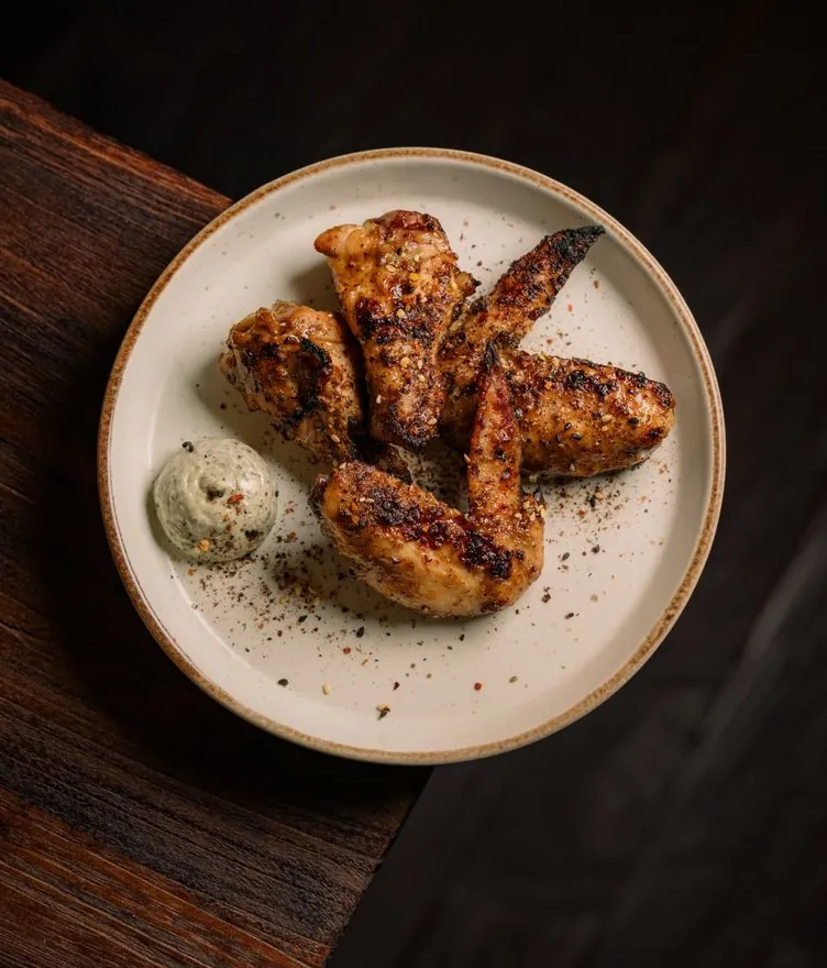 Robata chicken wings with nori mayo on a stoneware plate